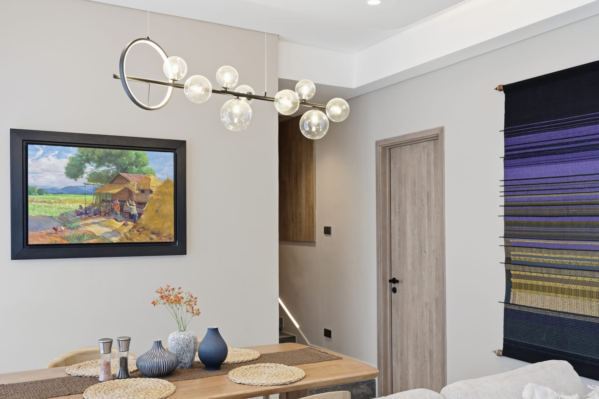 The suite's entry hallway — framed Chootoun landscape, console and the great room opening beyond