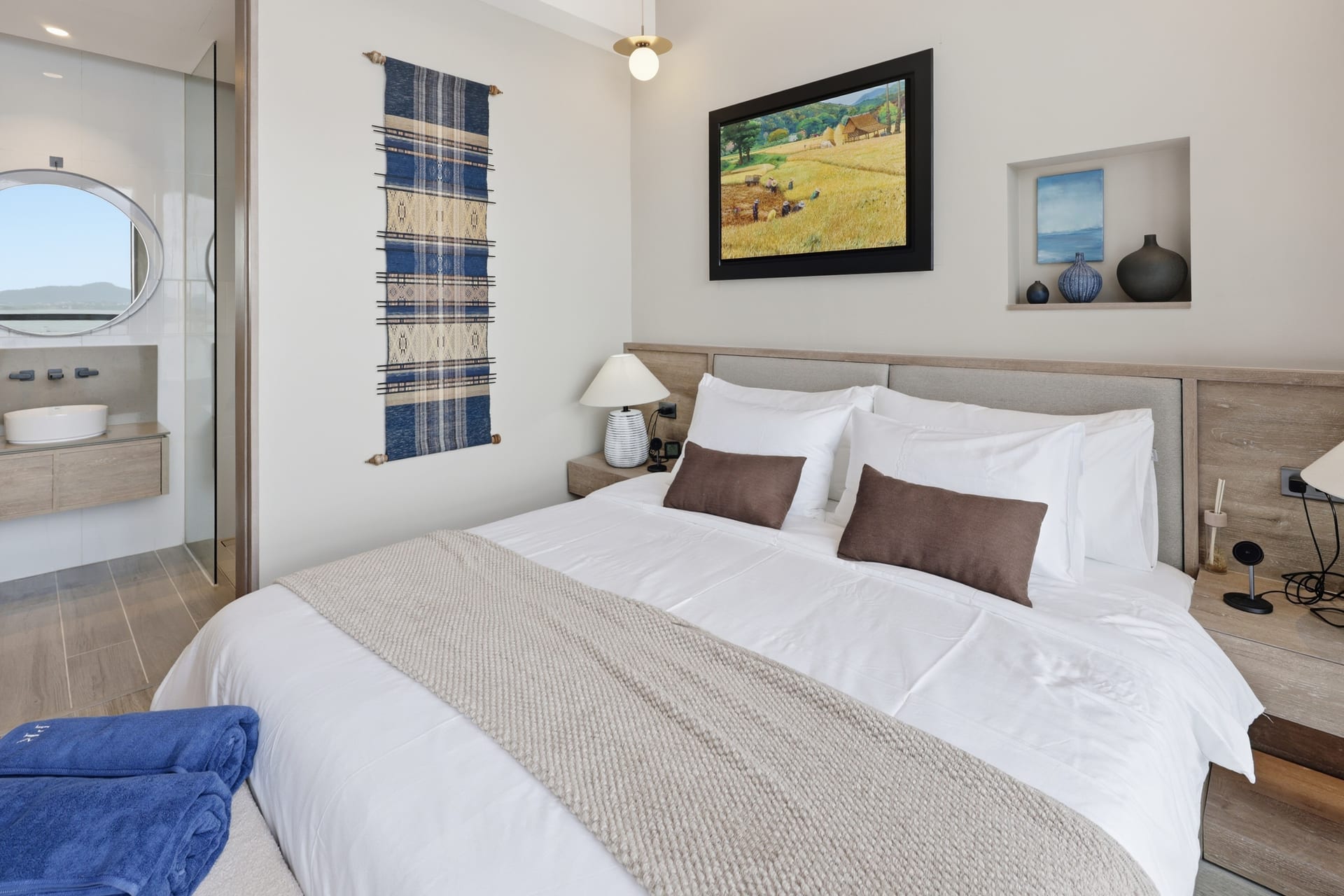 Primary bedroom with king-size Herva memory-foam bed and original Niwat Chootoun Thai landscape painting