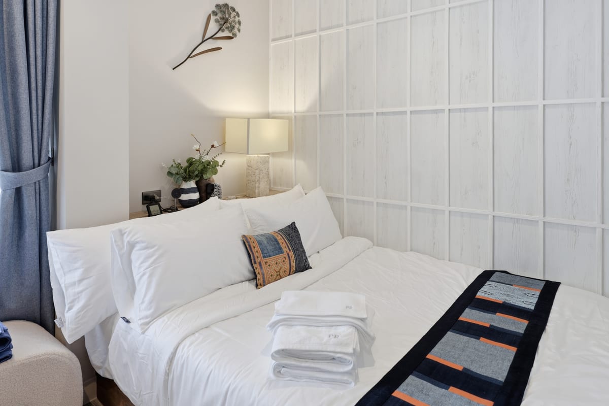 Second bedroom with queen-size Herva memory-foam bed and sea view through window