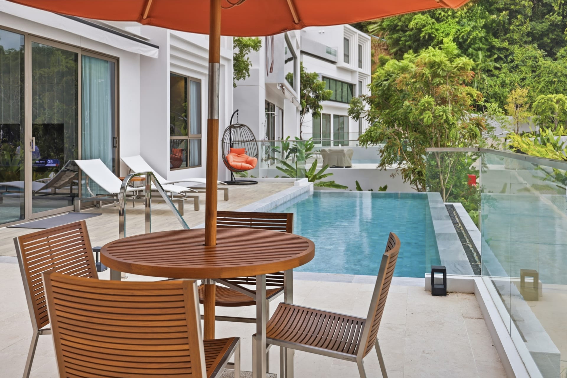 Hanging cocoon chair on the pool terrace with the Andaman in the background