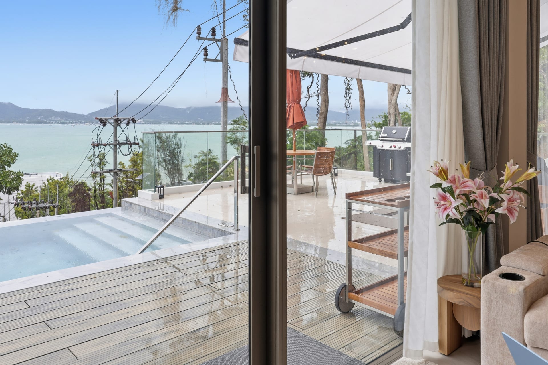 Daytime view from the terrace — uninterrupted Andaman Sea with outlying islands on the horizon